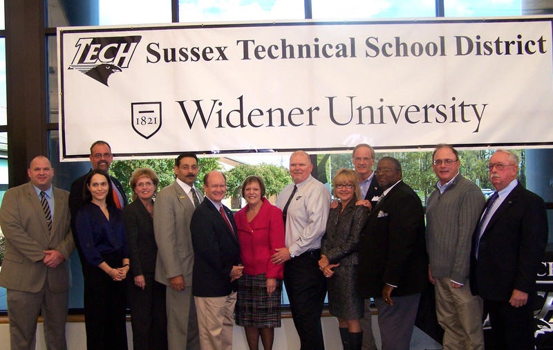 On hand to make the announcement of a partnership between Sussex Technical School District and Widener University are (l-r) Shawn Larrimore, Delmar School District director of curriculum and instruction; Dr. David Ring, Delmar School District superintendent; Rebecca Taber, policy adviser, Gov. Jack Markell's Office; Dr. Deborah Zych, Polytech School District superintendent; Jorge Melendez, Delaware State Board of Education vice president; U.S. Sen. Christopher Coons; Dr. Brenda Gilio, Widener University acting dean, School of Education, Innovation and Continuing Studies; Dr. AJ Lathbury, Sussex Technical School District superintendent; Melody Booker, Delaware Office of Economic Development: U.S. Sen. Thomas R. Carper; John Oliver, Sussex Technical School District Board of Education vice president; Pat Cooper, Sussex Technical School District Board of Education president; and George Torbert, Sussex Technical School District Board of Education member. SOURCE SUBMITTED